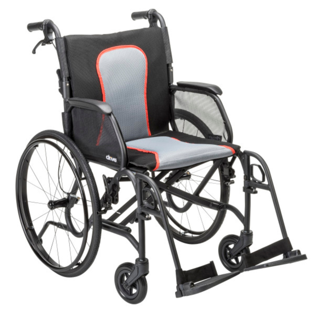 The Drive AeroFly™ Ultra-Lite Wheelchair with Companion Brakes features a lightweight magnesium alloy frame, large rear wheels, small front wheels, armrests, footrests, and a gray seat with red trim—ideal for travel.